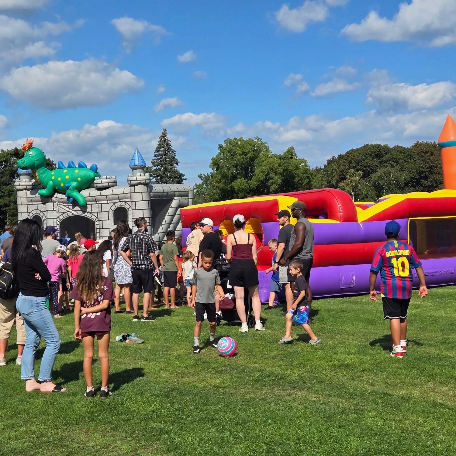 Families at the kids station with bouncy castles and games